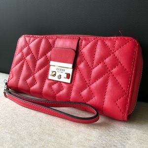 Woman’s red GUESS clutch